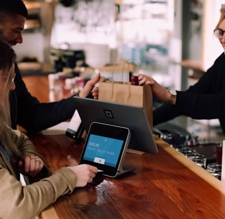 people using devices on brown table